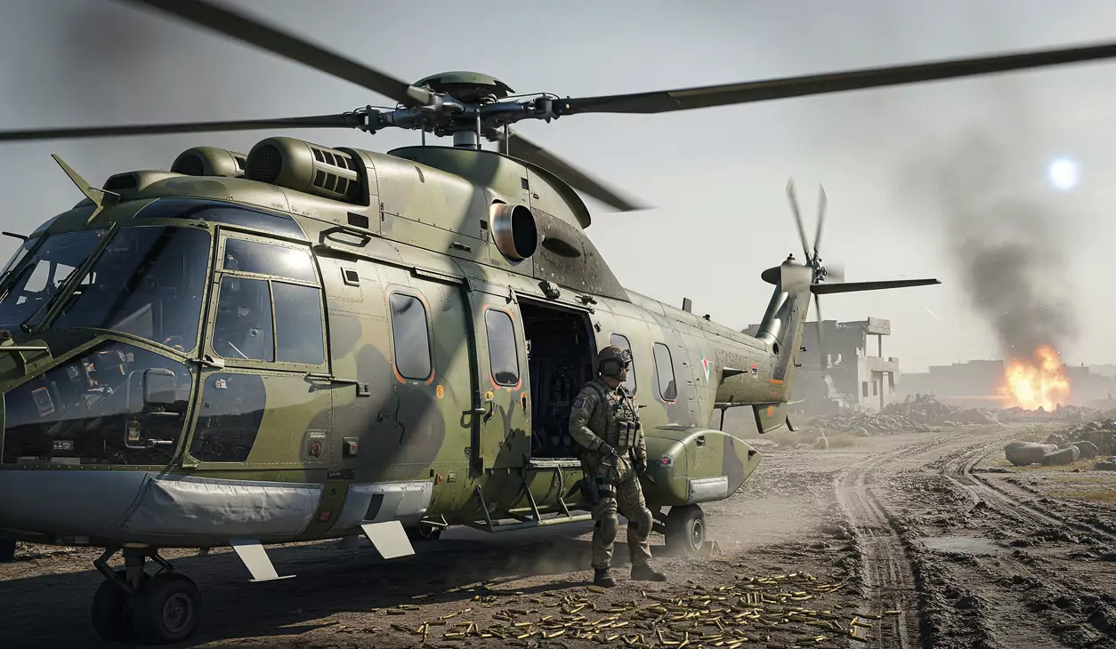 Helikopter wojskowy stoi na polu, żołnierz opiera się o otwarte drzwi. Na ziemi leżą łuski, w tle jest dym i ogień.